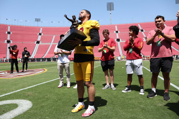 Caleb Williams holds the Heisman Trophy during the USC Trojans Spring Game.